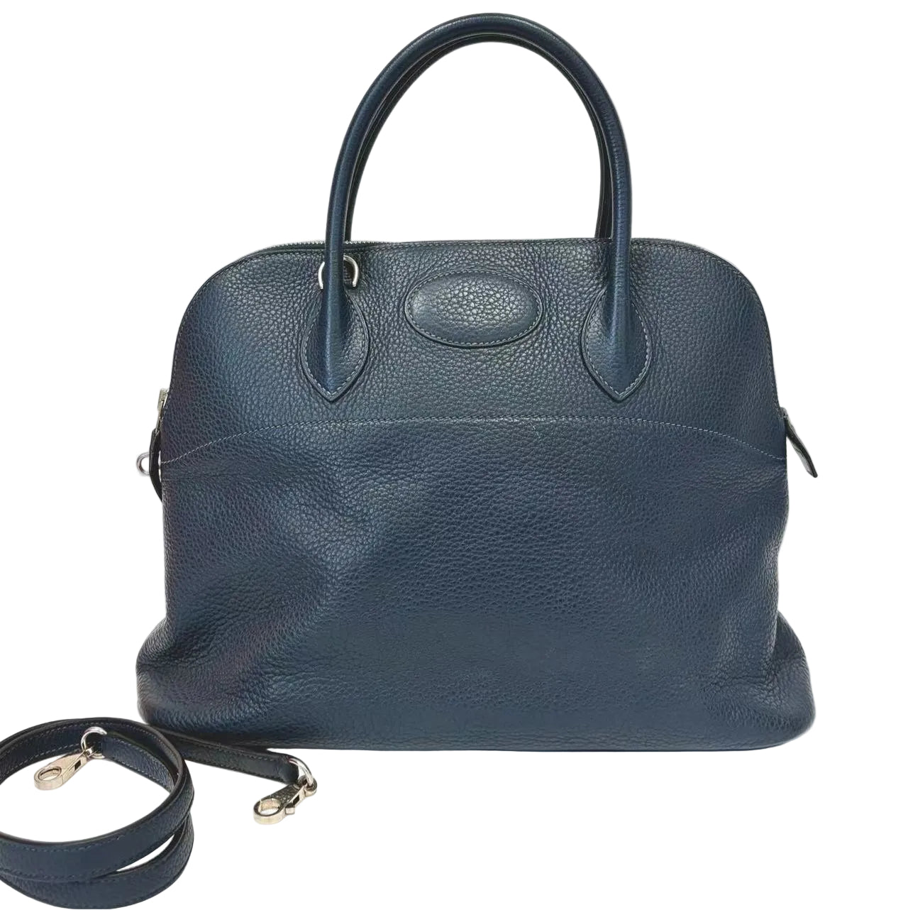 Blue leather handbag with a strap on a white background