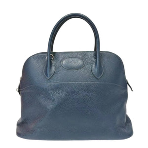 Blue leather handbag on a white background