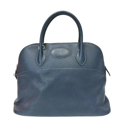 Blue leather handbag on a white background