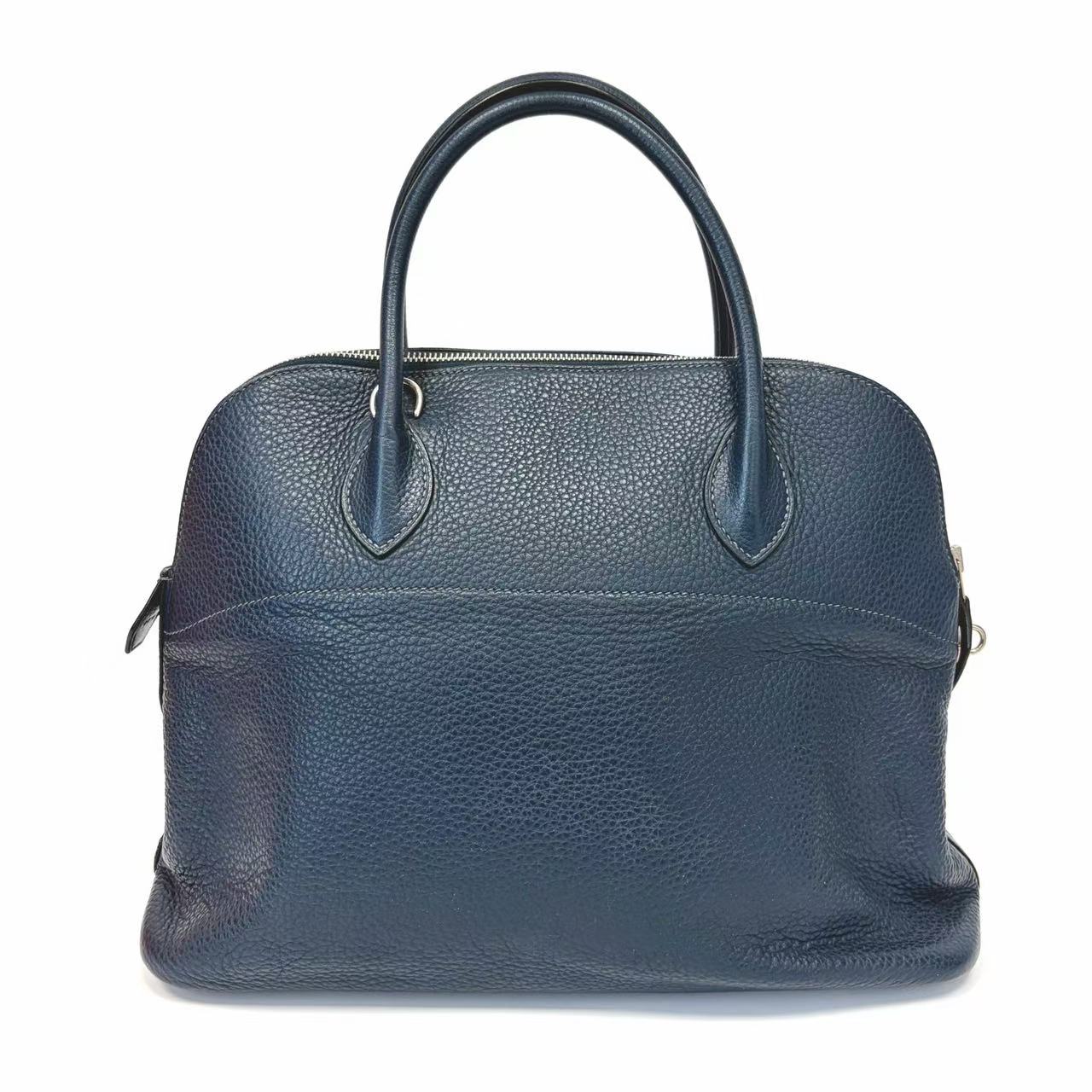 Blue leather handbag on a white background