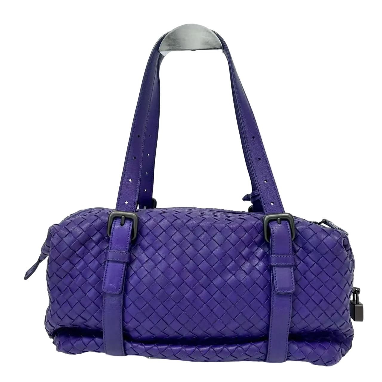 Purple woven handbag with a handle on a white background