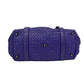 Purple woven handbag on a white background