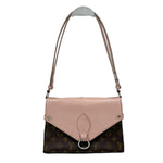 Two-tone handbag with pink top half and brown monogrammed bottom half on a white background