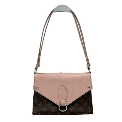 Two-tone handbag with pink top half and brown monogrammed bottom half on a white background