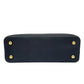 Black handbag with gold studs on a white background