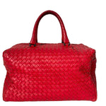 Red woven handbag on a white background