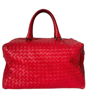Red woven handbag on a white background