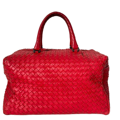 Red woven handbag on a white background