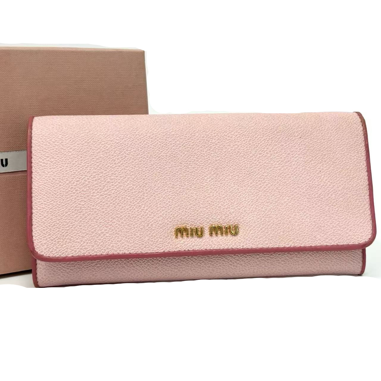 Pink wallet with 'Miu Miu' logo on a white background