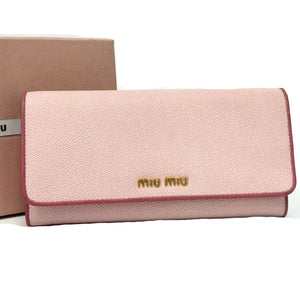 Pink wallet with 'Miu Miu' logo on a white background