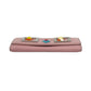 Pink clutch bag with colorful accents on a white background